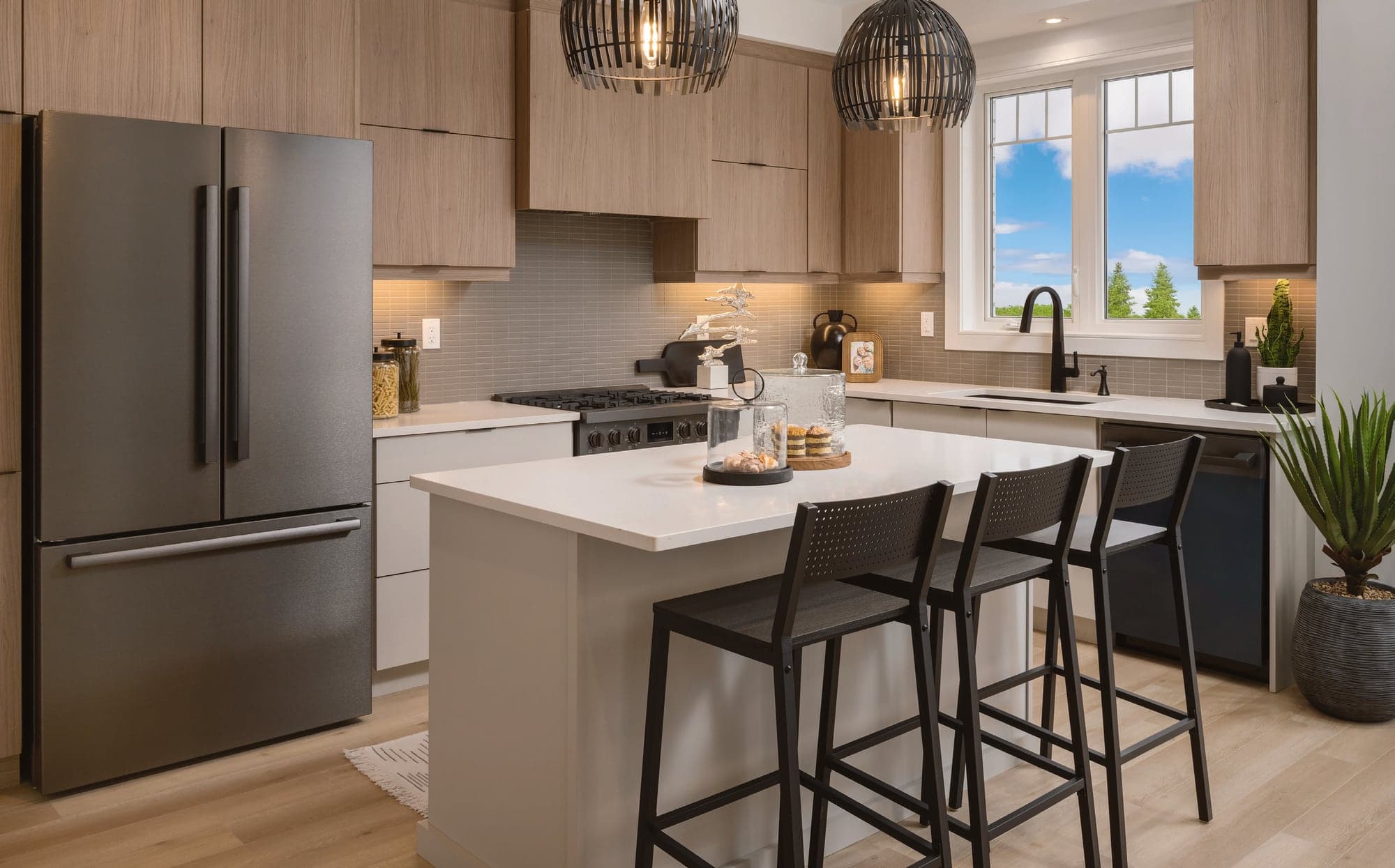 Kitchen with quartz island and stainless appliances. Artist's concept.