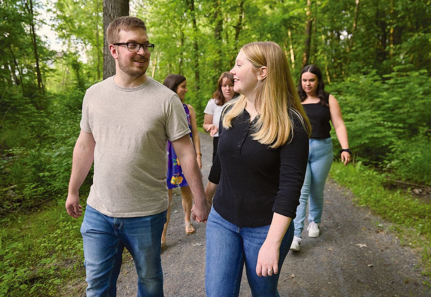 Couple walking a wooded trail
